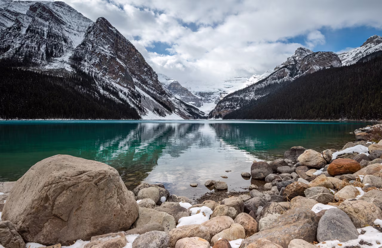Lake, surrounded by towering snow-capped mountains.